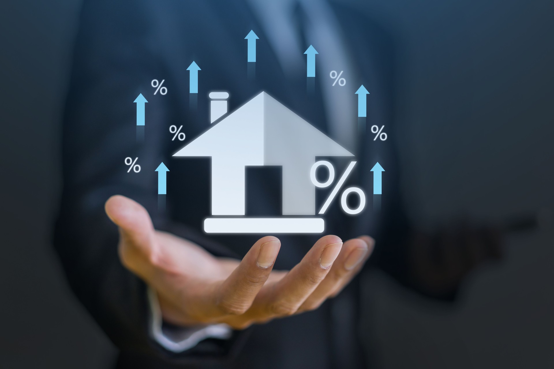 Businessman hold house with percentage, concept of real estate market trends, mortgage rates, property investment and housing market analysis, interest rates and financial planning, home ownership